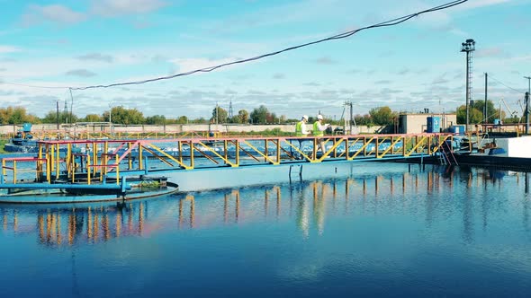 Inspectors are Walking Along the Pipes of Sewage Cleaning Plants