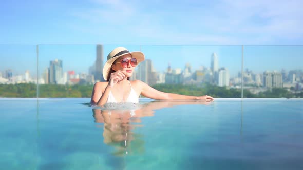 Young asian woman enjoy around outdoor swimming pool for leisure