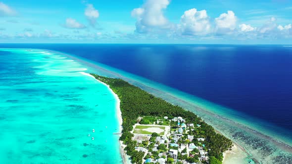 Natural drone travel shot of a sandy white paradise beach and blue water background 