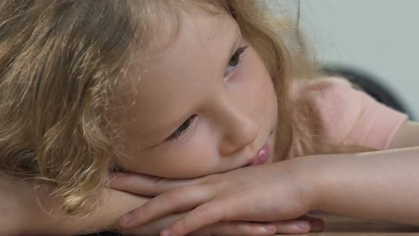 Depressed Kid Resting Head on Arms and Thinking About Family Issues, Problems