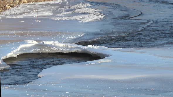 Natural Ice Bridge Over River Flowing Through Ice Floes