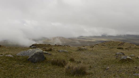 Time lapse of low clouds moving over rocky landscape