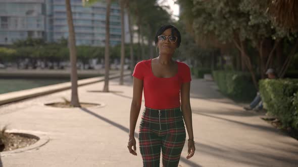 Woman Walking Towards Camera With Hands On Hips