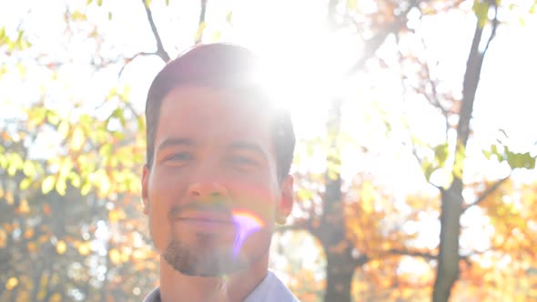 View on a Young Handsome Man Who Looks Satisfied, Stare Into Camera and Stands in the Woods - Detail