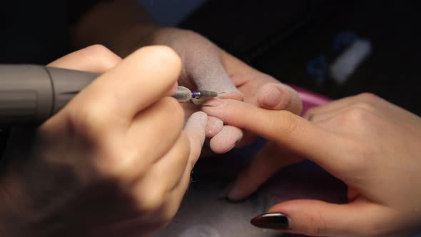 Anonymous Beautician Doing Manicure to Female Client