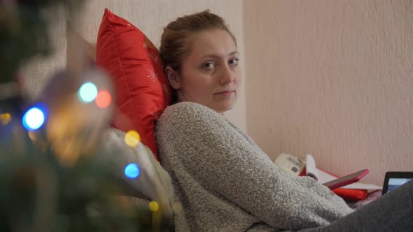 Woman Looking At Camera Christmas Interior