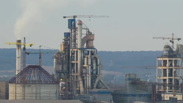 Timelapse of Cement Plant with High Factory Structure and Tower Cranes at Industrial Production Area