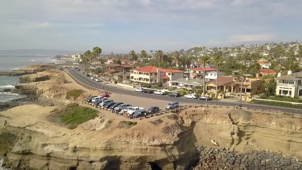 Parking on the cliff panorama of the coast. Wonderful aerial view flight fly backwards drone footage