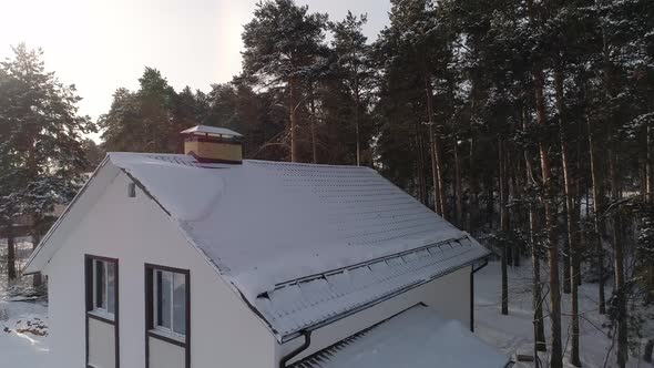 Drone shot of new white modern residential house at winter near the forest 15