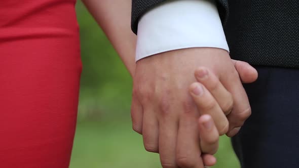 Front View of Couple in Love Holding Hands. Close up of Young Couple's Hands. Romantic Love Concept