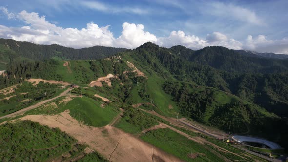 Green Hills and Mountains with White Clouds