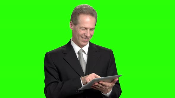 Cheerful Businessman Using Tablet.