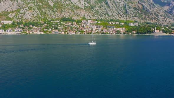 Sailing Yacht in the Sea in the Distance you Can See the Coast with Mountains in Kotor Bay