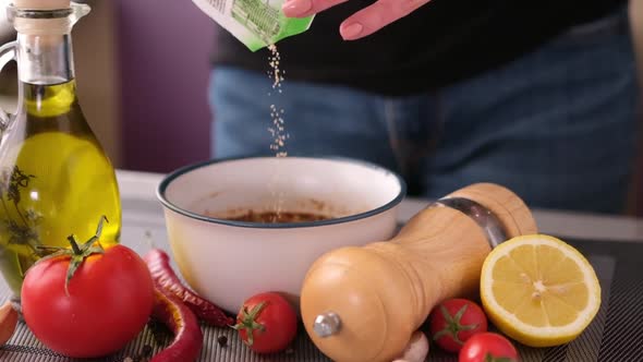 Preparing a Marinade Sauce for Bbq in a Domestic Kitchen  Adding Salt and Spices