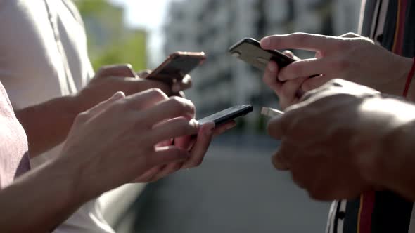 Side View of Young People Using Smartphones.