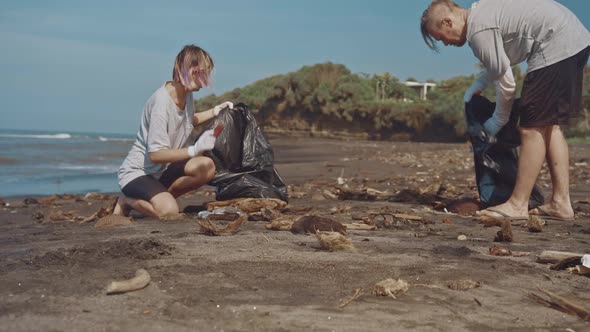 A Couple of Volunteers Cleaning on the Beach