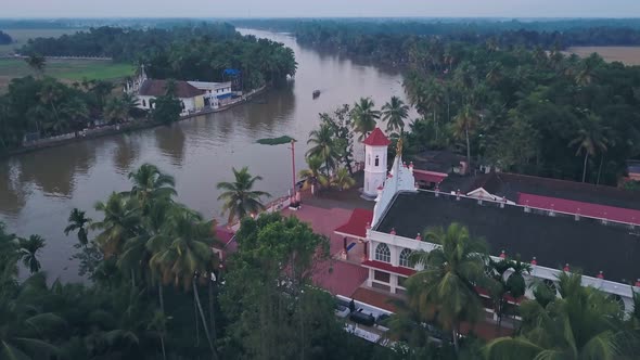 Boat tour on Kerala backwaters at Alleppey with temple in India. Aerial drone view