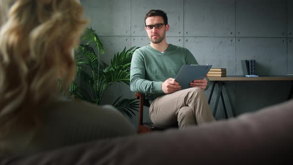 Young psychotherapist with a patient in the office