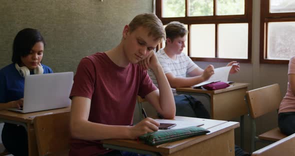 Teenagers in a school classroom alt