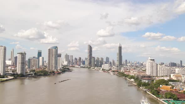 Aerial view of Chao Phraya River with Bangkok Skyscrapers Background on Cloudy day, Thailand