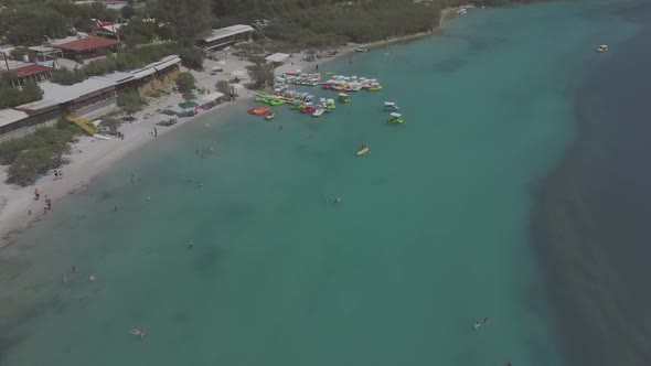 Aerial view of Kournas Lake, Greece. Little pier with pedal boats in the water