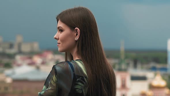 Happy Woman Tourist Enjoys Large City View on Spring Day