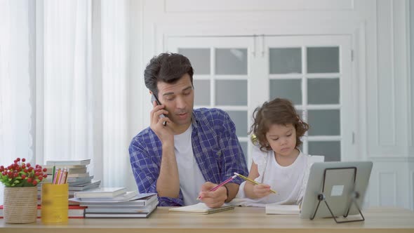 Business dad trying to work by making a phone call while take care his daughter together in home