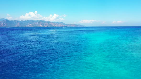 Aerial panorama of perfect island beach vacation by blue ocean with white sandy background of advent