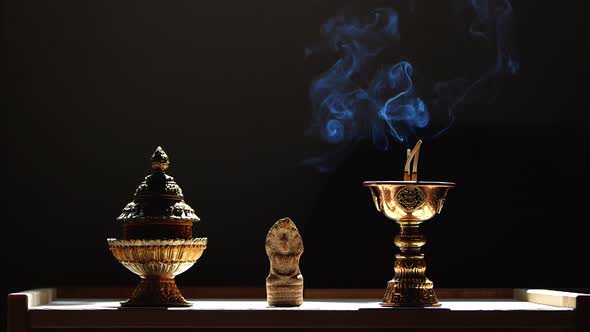 Blue Smoke From a Burning Stick Slowly Rises Up in the Buddha Temple