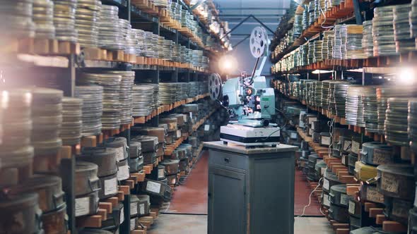 Shelves with Movie Tapes and Antique Projector Between Them