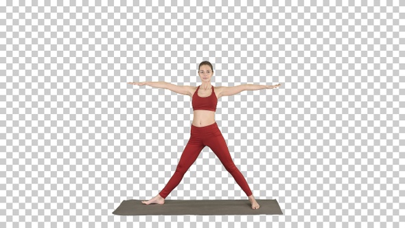 Woman practicing yoga standing in Extended Side Angle exercise,