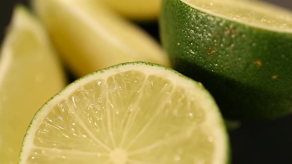 Fresh Juicy Limes Cut in Halves Turning on Stand, Preparation of Cocktails