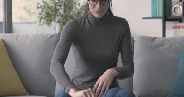 Woman working with a laptop and smiling at camera