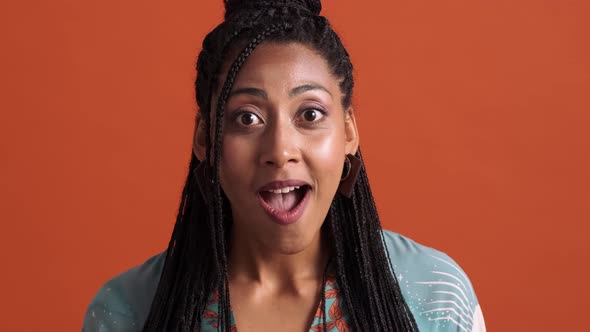 A close-up view of a surprised african american woman rejoicing