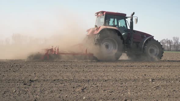 Tractor In A Field Preparing Soil
