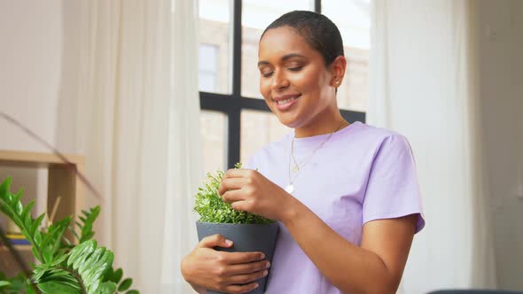 African American Woman with Plants at Home