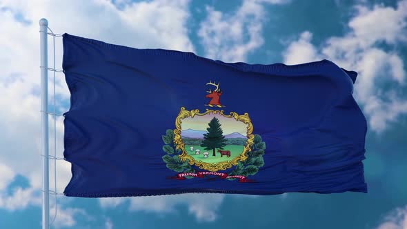 Vermont Flag on a Flagpole Waving in the Wind Blue Sky Background