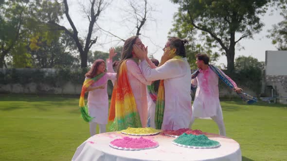 Romantic Indian couple playing Holi