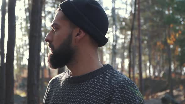 Bearded Man in the Forest Looking Far Ahead