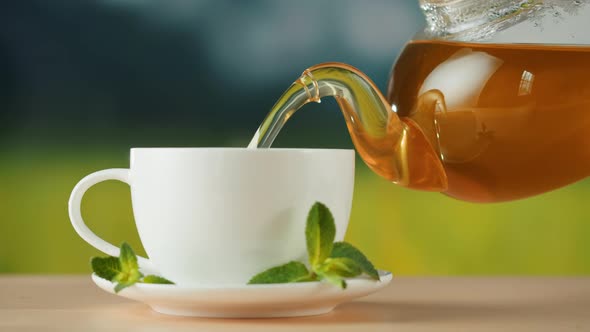 Pouring Hot Tea in White Cup Closeup