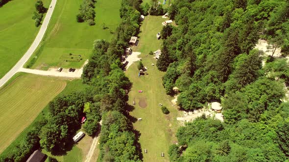 Aerial view of a summer camp with cabins in the forest at Slovenia.