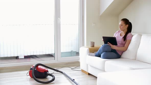 Woman with Tablet Pc and Coffee After Cleaning