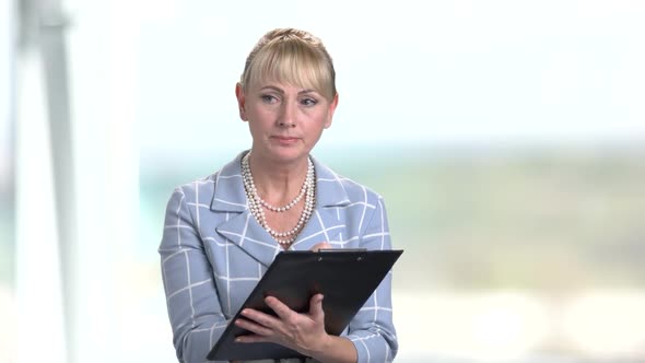 Mature Blonde Supervisor with Clipboard