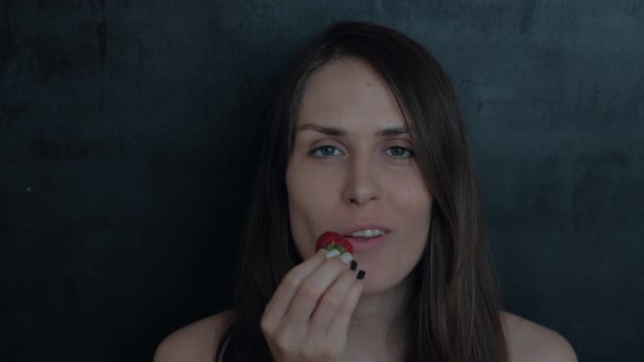 Sexy Young Girl With Red Lipstick Eating Strawberries