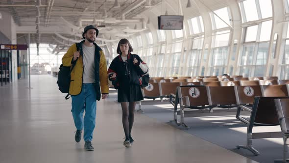 Busy People Walking at Empty Airport Terminal with Backpacks While Going to Flight Boarding Gate