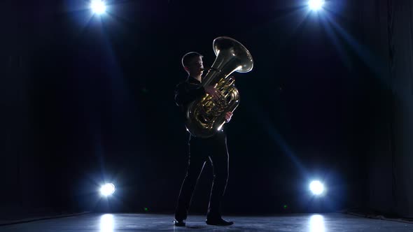 Musician in Dark Studio with Spotlights Playing Tuba Slow Jazz