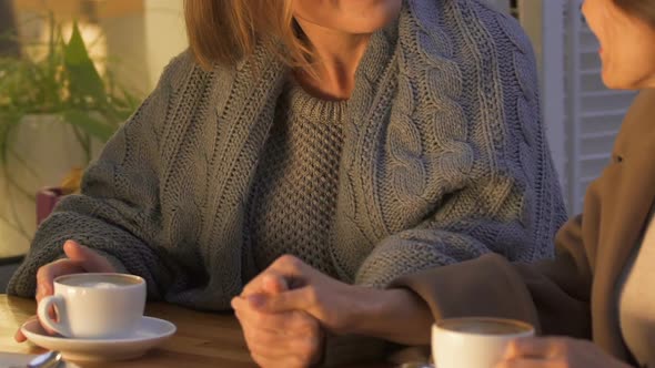 Women Holding Hands and Talking, Confidential Conversation in Cozy Evening