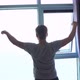 Back of View of Young Man Unveil Curtain and Stretches Arms in the Morning - VideoHive Item for Sale