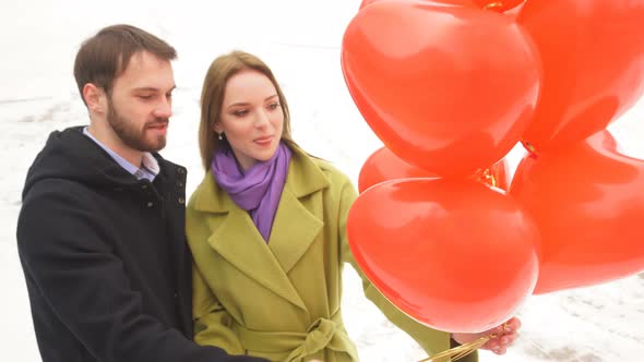 Romantic Date Outdoors in the Park on a Winter Day. Date of a Happy Young Couple. A Man and a Woman