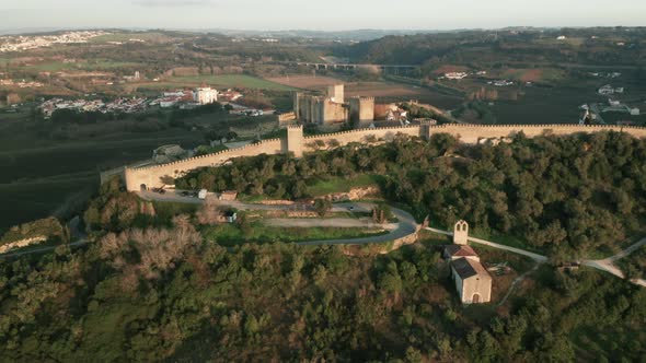 Panoramic View Of Medieval Town And Castle Surrounded By Lush Green Foliage In Obidos, Portugal. - A